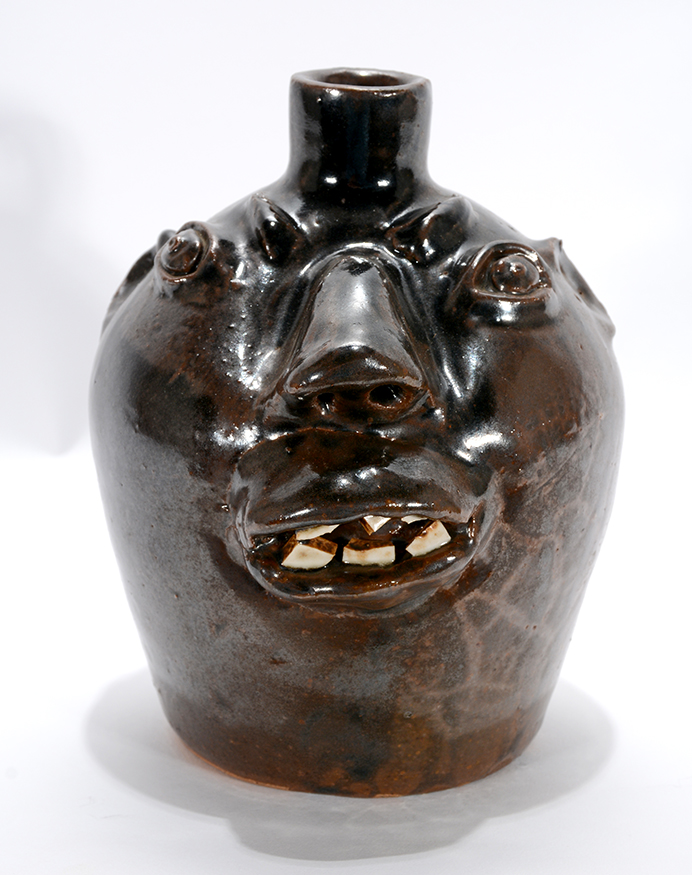 Lot 103 – Brown Brothers pottery, pint-size face jug with china teeth, circa 1950s, 6 1/2in high. Estimate: $1,000-1,500. Slotin Auction image