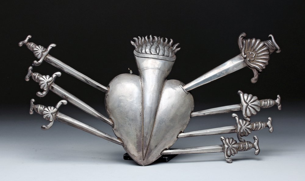 Nineteenth century Bolivian sterling silver Sacred Heart with seven swords (one removable) representing the seven sorrows, 14 1/2in wide x 7 1/4in high. Estimate: $500-$700. Artemis Gallery Live image