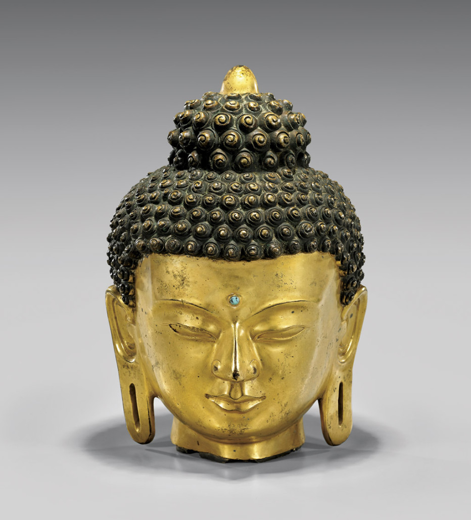 Large Tibetan bronze head of Buddha, 14th century, 15 1/2in high on metal stand. Estimate: $45,000-$60,000. I.M. Chait Gallery / Auctioneers image
