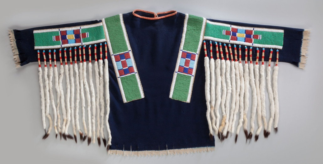 Plateau beaded hide and cloth shirt, circa 1885, navy blue and red wool trade cloth, length across the arms: 55 inches. Estimate: $15,000-$25,000. Heritage Auctions image 