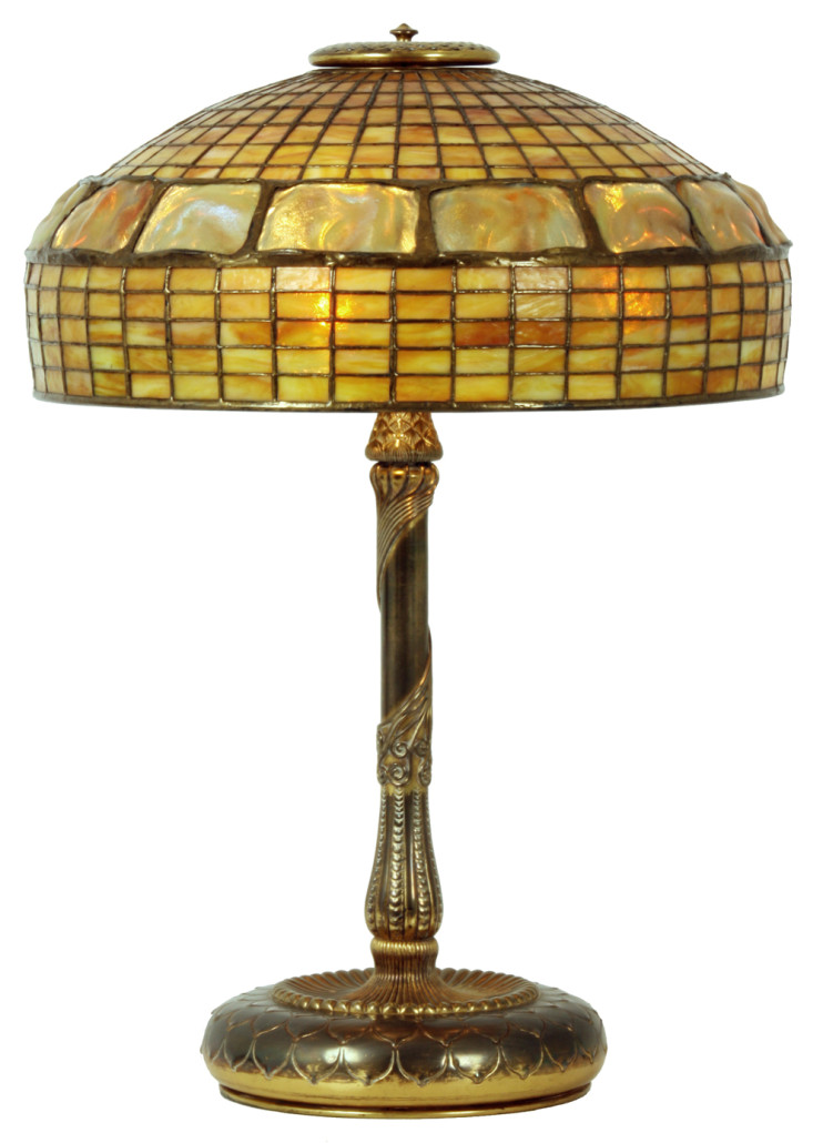 Tiffany Studios Gold Turtleneck table lamp with an 18-inch shade, and with a geometric brick background, on a polished gilt bronze base. Estimate: $25,000-$35,000. Fontaine's Auction Gallery image