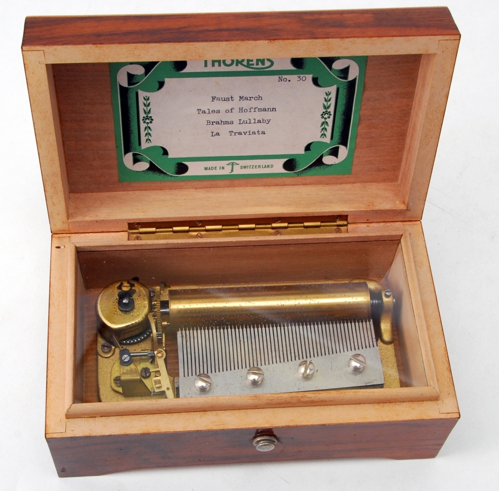 Thorens Swiss music box in excellent working condition, playing four classical tunes and housed in a gorgeous case with one inlay. The Specialists of the South Inc. image
